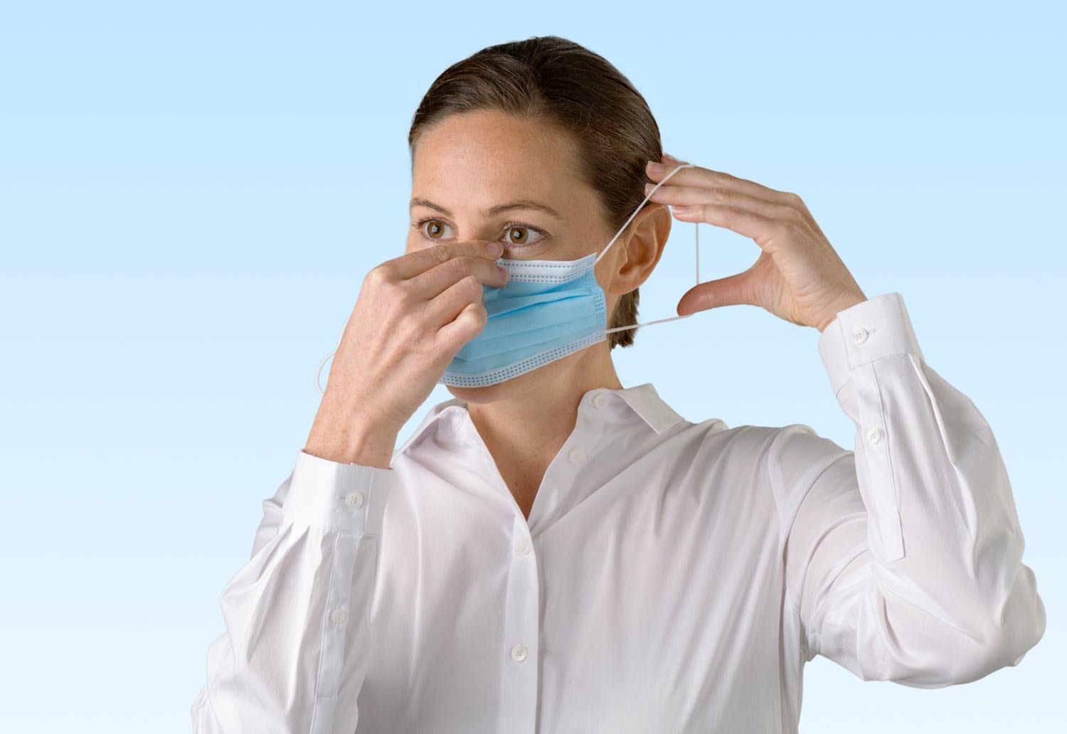 Image of a person putting on a face mask