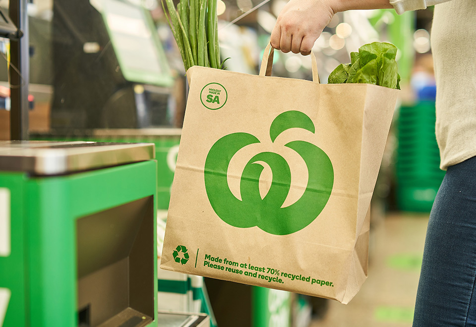 Woolworths paper bag being used in-store