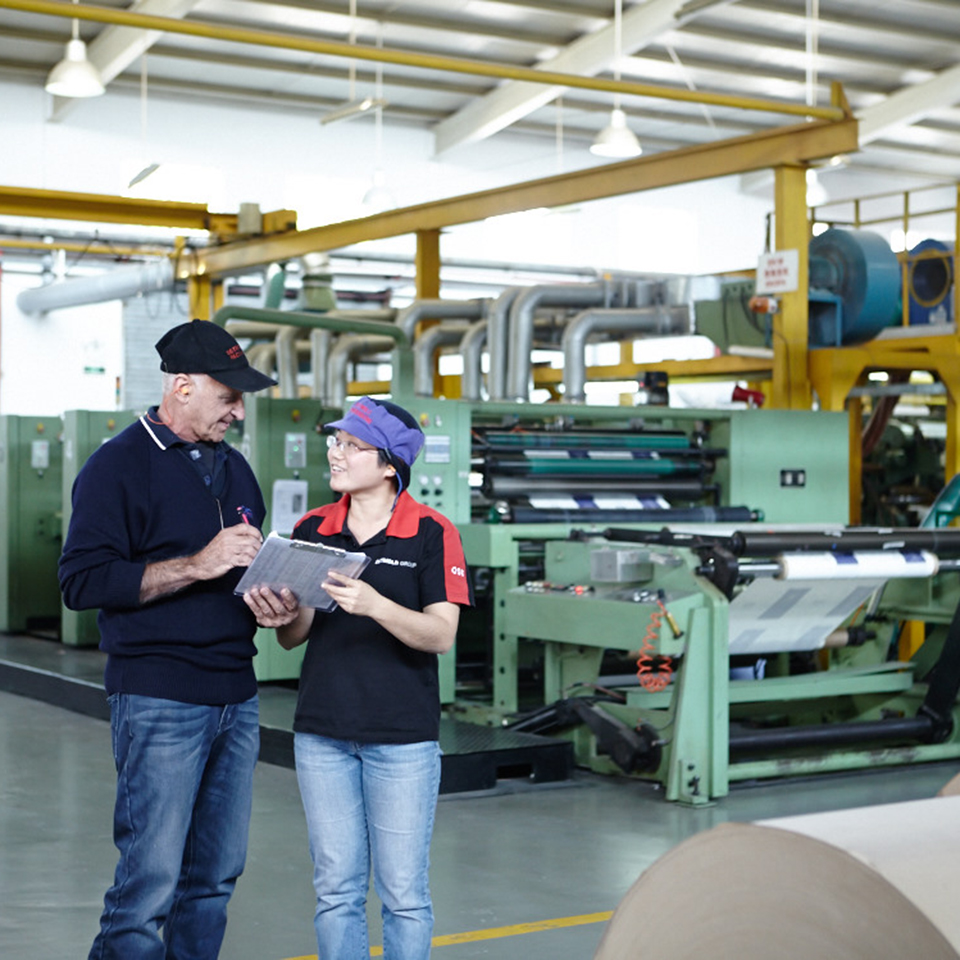 Image of two people looking at clipboard